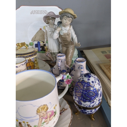 92 - A mixed lot of china and ceramics to include commemorative ware, a Lladro model, two Nao figures and... 