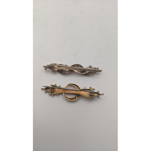 22 - Two early 20th century 9ct gold bar brooches one fashioned as a crescent moon set with a ruby and pe... 