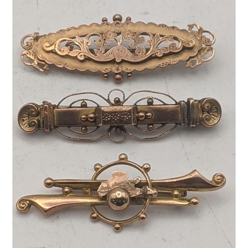 34 - Three Victorian 9ct gold brooches with later pins to include one decorated with a floral piece desig... 