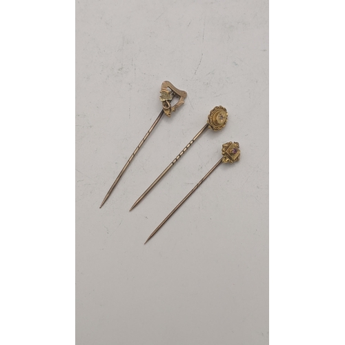 41 - Three 15ct gold stick pins all on yellow gold pins tested as 9ct to include a Victorian example set ... 