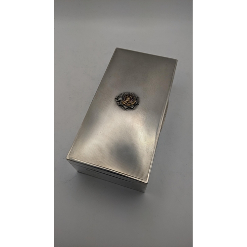 45 - A silver cigarette box with an engine turned lid and also having a Royal army service corks to the t... 