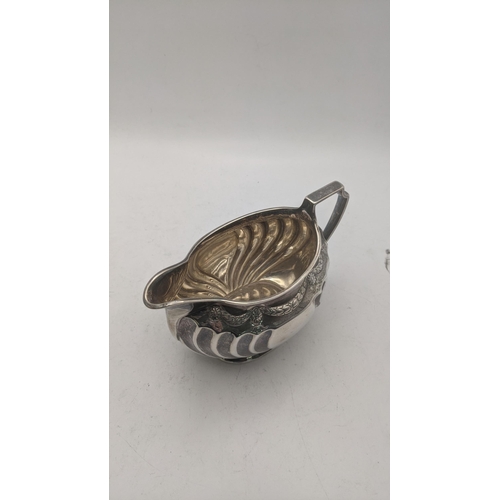 46 - A silver milk jug having embossed decoration hallmarked Sheffield 1888, 151.2g
Location: CAB 1
If th... 