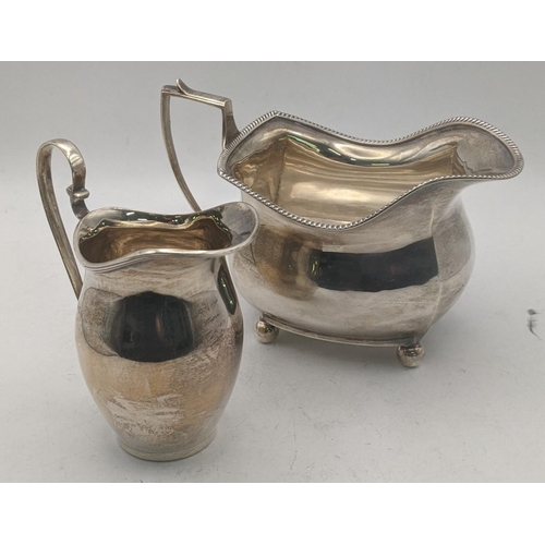 50 - Silver to include a sauce boat on four ball feet hallmarked Chester 1939, together with a cream jug,... 