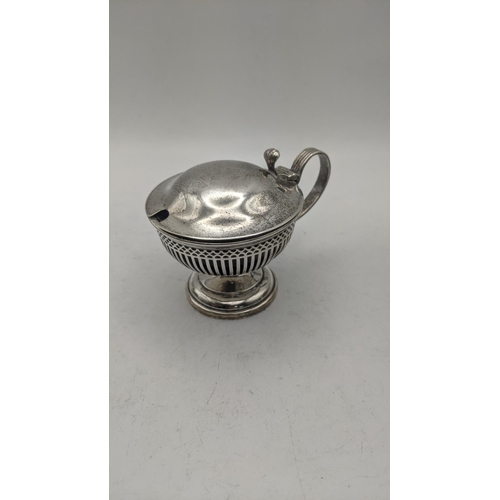 54 - Silver to include a group of pierced mustard pots and a salt's all with blue glass liners, total wei... 