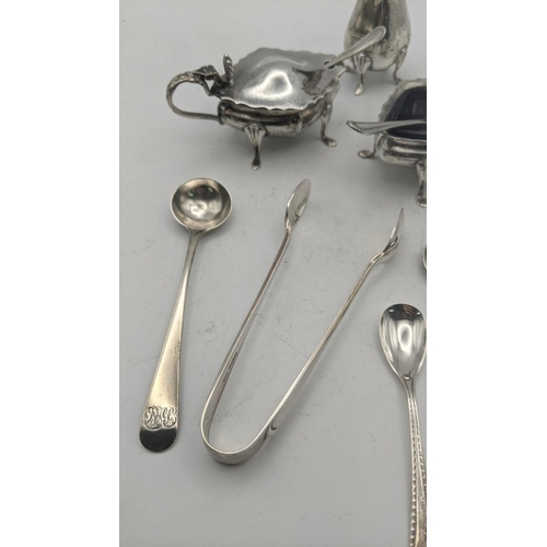 56 - Silver to include a set of condiments together with a variety of condiment spoons, a teaspoon, and a... 