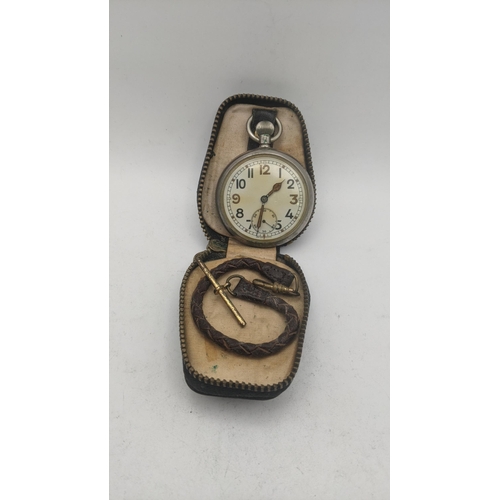 60 - A WWI military pocket watch engraved to the back G.S.T.P M82896 A/F with a brown pocket watch strap
... 