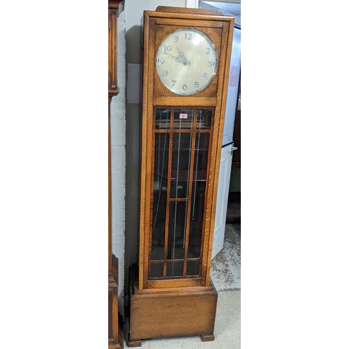 24 - An Art Deco oak longcase clock with a glazed panelled door and Arabic dial
Location:FOYER
If there i... 