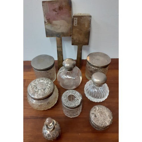 42 - A quantity of dressing table items to include silver topped glass jars, an Art Deco silver monogramm... 