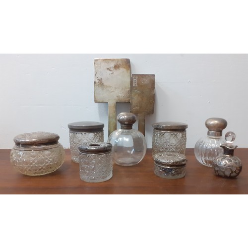 42 - A quantity of dressing table items to include silver topped glass jars, an Art Deco silver monogramm... 