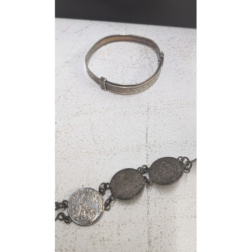 257 - Silver to include two British coin bracelets, a child's bangle, sterling silver pickle for, silver h... 