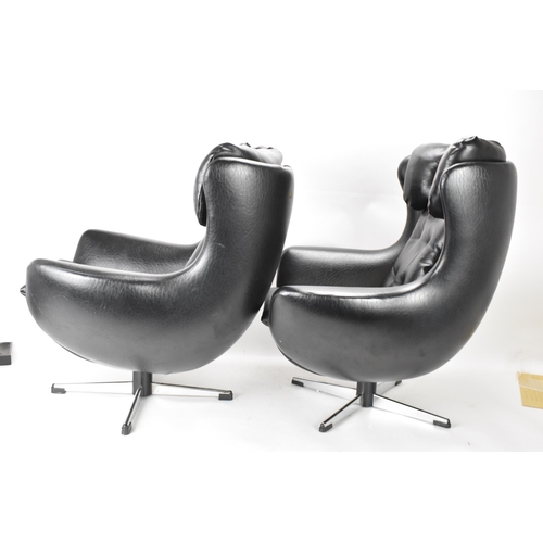 568 - Two Parker Knoll 1980s retro Arne Jacobsen style children's swivel chairs, each with black leather b... 