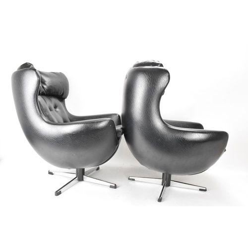 568 - Two Parker Knoll 1980s retro Arne Jacobsen style children's swivel chairs, each with black leather b... 