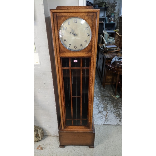 24 - An Art Deco oak longcase clock with a glazed panelled door and Arabic dial
Location:FOYER
If there i... 