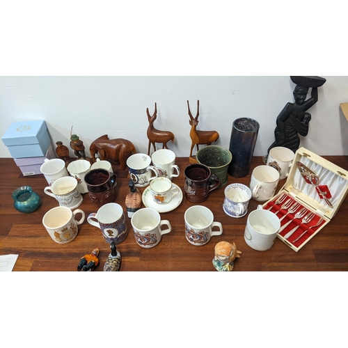 28 - Ceramics to include a Beswick model owl, commemorative mugs, wooden animals, Marfa glass vase and ca... 