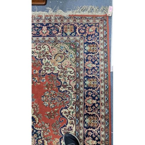 337 - A Persian hand woven rug having a central motif, floral design and multiguard borders, 255cm x 176cm... 