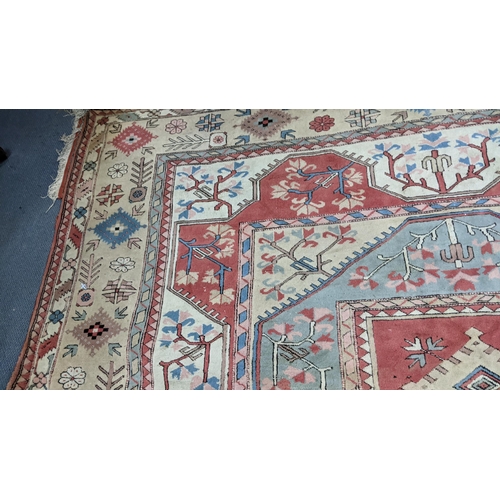 338 - A Turkish Milas Toban hand woven carpet having geometric designs, three central lozenge motifs and t... 