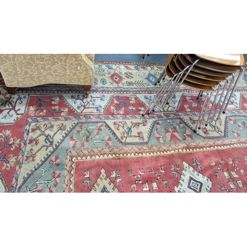 338 - A Turkish Milas Toban hand woven carpet having geometric designs, three central lozenge motifs and t... 