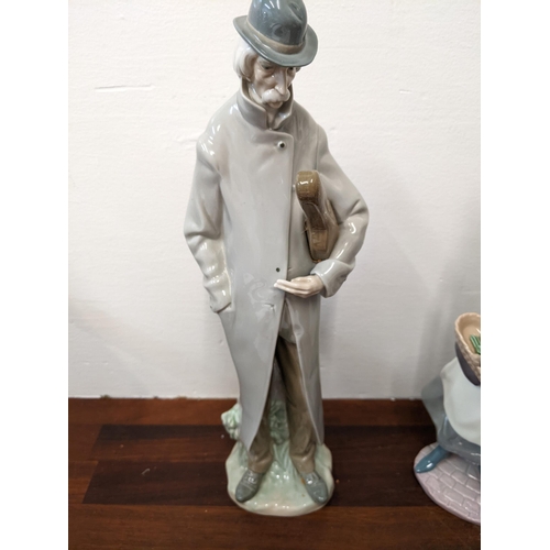 403 - Two Lladro figurines to include 'Old Man with Violin' and 'Tokens of Love' both in original boxes
Lo... 