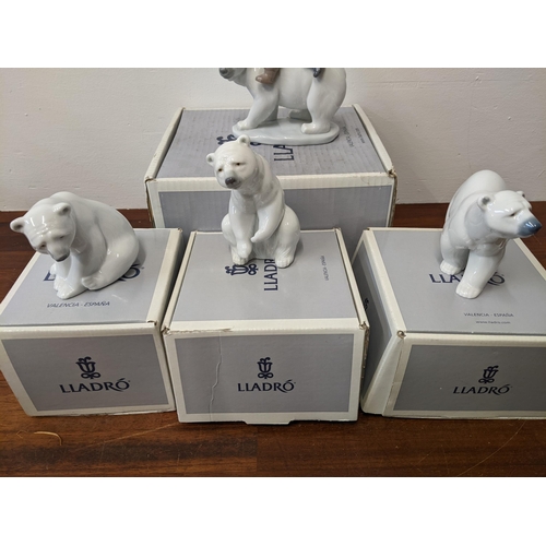 404 - Lladro figures to include three polar bears and 'Eskimo Riders' all in their original boxes and pack... 