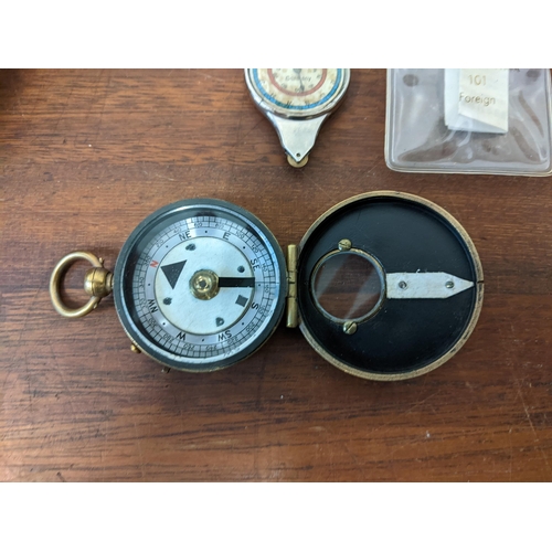 446 - A Barker & Son marching military compass No50 in a leather case, a brass cased compass in leather ca... 