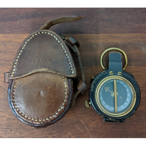 446 - A Barker & Son marching military compass No50 in a leather case, a brass cased compass in leather ca... 