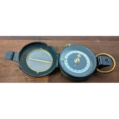 446 - A Barker & Son marching military compass No50 in a leather case, a brass cased compass in leather ca... 