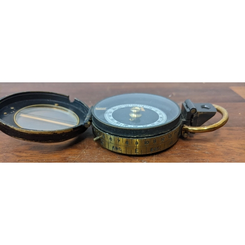 446 - A Barker & Son marching military compass No50 in a leather case, a brass cased compass in leather ca... 