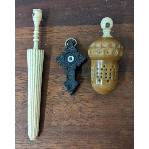 447 - A bone stanhope and another carved nut containing a silver thimble and a carved wooden cross
Locatio... 