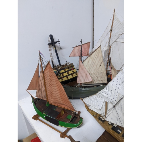 463 - A fleet of wooden model sailing vessels to include a large three-masted model of HMS Victory, and a ... 