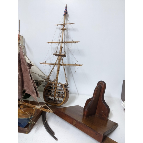 463 - A fleet of wooden model sailing vessels to include a large three-masted model of HMS Victory, and a ... 