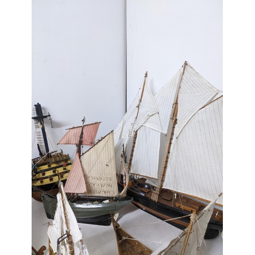 463 - A fleet of wooden model sailing vessels to include a large three-masted model of HMS Victory, and a ... 