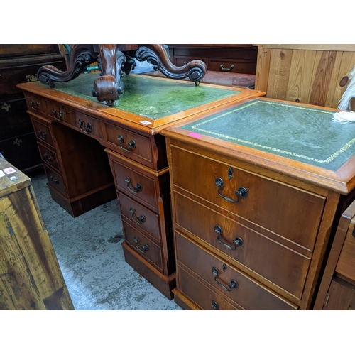 473 - A reproduction mahogany twin pedestal desk and matching two-drawer filing cabinet, each with inset g... 