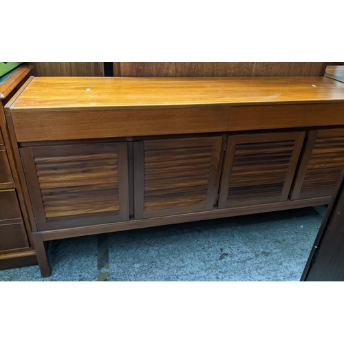 476 - A mid-century teak sideboard, two drawers above four louvred cupboard doors on square legs 75cm x 15... 