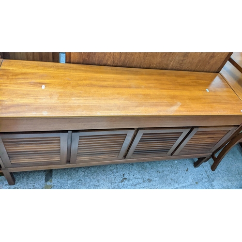 476 - A mid-century teak sideboard, two drawers above four louvred cupboard doors on square legs 75cm x 15... 