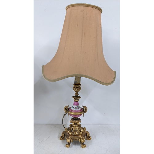 502 - A late 19th century Louis XV style gilt metal table lamp with Sevres style painted centre, on acanth... 