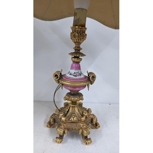 502 - A late 19th century Louis XV style gilt metal table lamp with Sevres style painted centre, on acanth... 