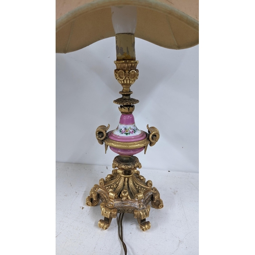 502 - A late 19th century Louis XV style gilt metal table lamp with Sevres style painted centre, on acanth... 