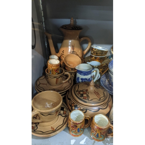 513 - A mixed lot of ceramic and pottery examples to include a Poole pottery dish, coffee pot,cans and sau... 