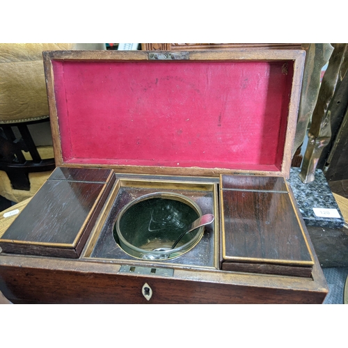 523 - A late 19th/early 20th century rosewood tea caddy of sarcophagus form with the presentation glass an... 