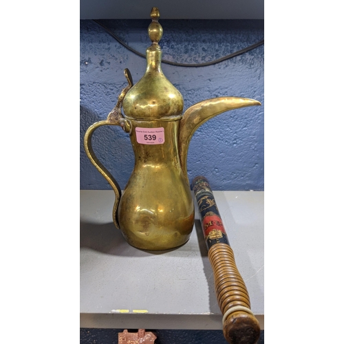 539 - A police truncheon and an early 20th century brass jug, possibly from Turkey, the truncheon decorate... 