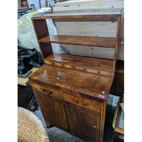 593 - An early 20th century walnut side cabinet of small proportions, gilt metal galleried top over two op... 