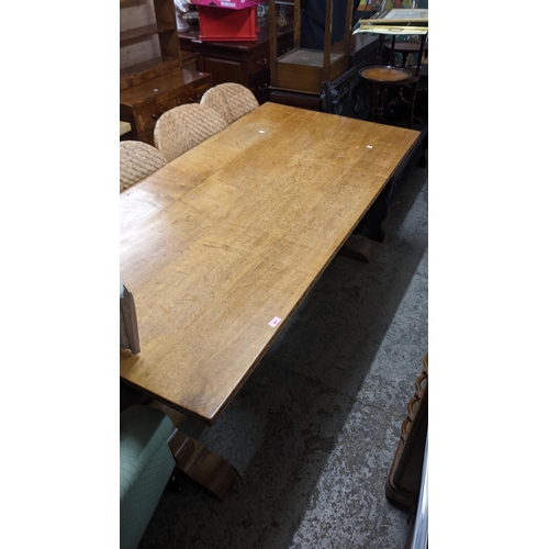 601 - A mid 20th century oak refectory table on carved cup and cover columns and block feet, 76cm high x 1... 