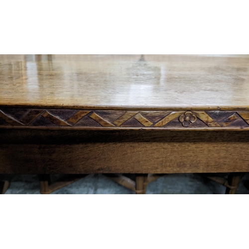 601 - A mid 20th century oak refectory table on carved cup and cover columns and block feet, 76cm high x 1... 