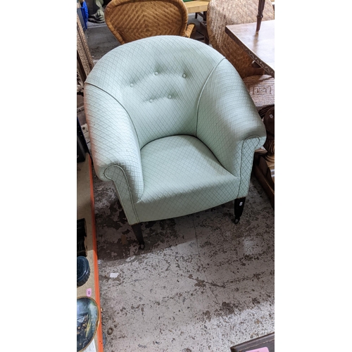 603 - An early 20th century tub chair with green upholstery on square tapered legs and castors
Location:G