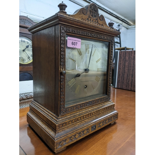 607 - A Winterhalder and Hofmeier oak cased mantel clock, silvered face with gilded Roman numerals (with p... 