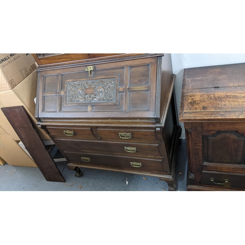 609 - A Victorian mahogany bookcase cabinet with twin glazed doors over a carved fall front two short and ... 