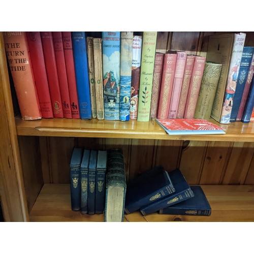 612 - A mixed lot to include a group of children's books, along with Charles Dickens books, travel books, ... 