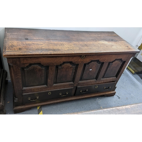 613 - A George III mahogany crossbanded oak chest with a hinged top and pannelled front with two drawers, ... 