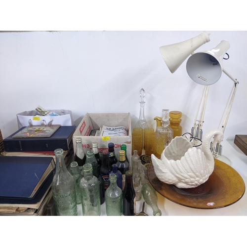 618 - A mixed lot to include various postcards and magazines, vintage glass bottles two Anglepoise lamps, ... 