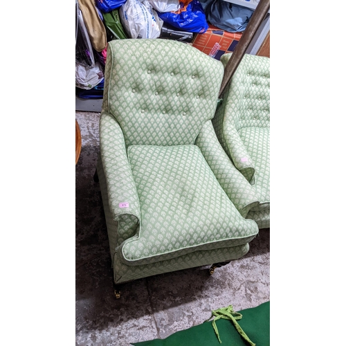 570 - Two similar 19th century armchairs, upholstered in green and white fabric, on turned mahogany legs
L... 